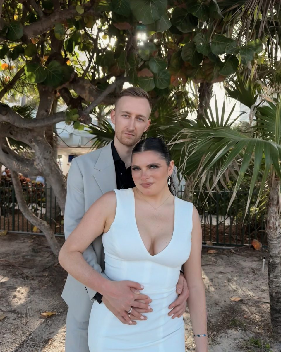 Couple embracing under sea grape trees